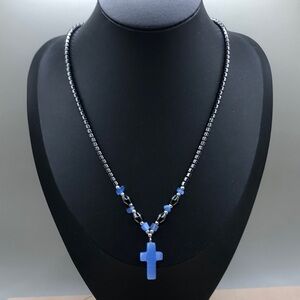Hematite bead and cat eye glass cross pendant necklace.